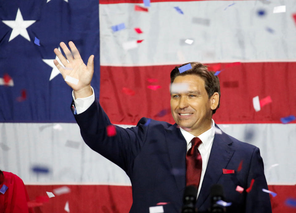 Gov. Ron DeSantis, jubilant, waves to the crowds in a blizzard of red, white and blue confetti.