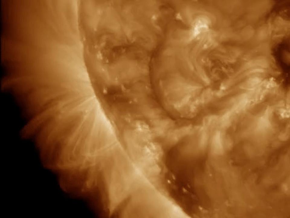 A flash of light appears where the solar flare is released on the left side of the sun.