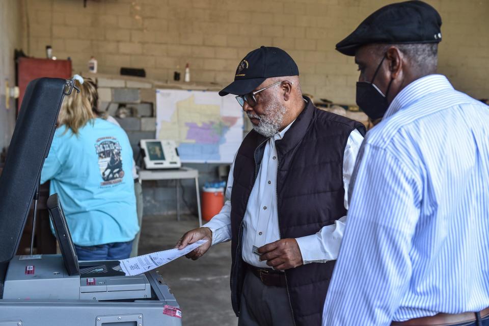 U.S. Rep. Bennie Thompson, D-Miss, shows up early Tuesday to cast his vote at his precinct with help from poll manager Willie Robinson in Bolton, Mississippi, on Nov. 8, 2022. Thompson is seeking re-election for his 2nd Congressional district seat.