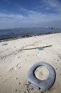 A toilet seat is seen on Galeao beach in the Guanabara Bay in Rio de Janeiro March 13, 2014. According to the local media, the city of Rio de Janeiro continues to face criticism locally and abroad that the bodies of water it plans to use for competition in the 2016 Olympic Games are too polluted to host events. Untreated sewage and trash frequently find their way into the Atlantic waters of Copacabana Beach and Guanabara Bay - both future sites to events such as marathon swimming, sailing and triathlon events. REUTERS/Sergio Moraes (BRAZIL - Tags: ENVIRONMENT SPORT OLYMPICS)