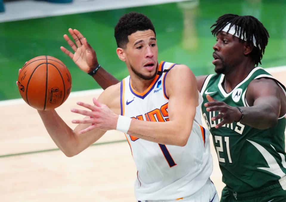 Suns guard Devin Booker (1) and Bucks guard Jrue Holiday will go from competing against each other to being Olympic teammates.