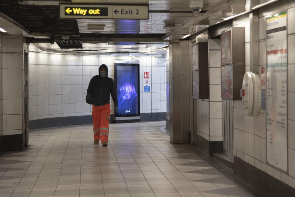 A commuter at Bank tube station in the City of London,UK on April 22, 2020. A virtual parliament has returned with most MP's working from home, the government has promised to increase testing to 100,000 a day by the end of the April, an increase of 82,000, as critisism of the governments handling of the pandemic mounts. (Photo by Claire Doherty/Sipa USA)