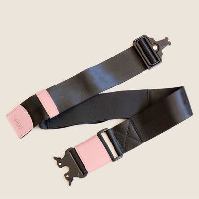 A travel belt to help you secure your personal item to the top of your rolling bag