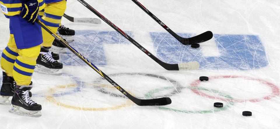 Members of Sweden's women's ice hockey team run warm up drills before facing Japan during the 2014 Winter Olympics women's ice hockey game at Shayba Arena, Sunday, Feb. 9, 2014, in Sochi, Russia. (AP Photo/Matt Slocum)