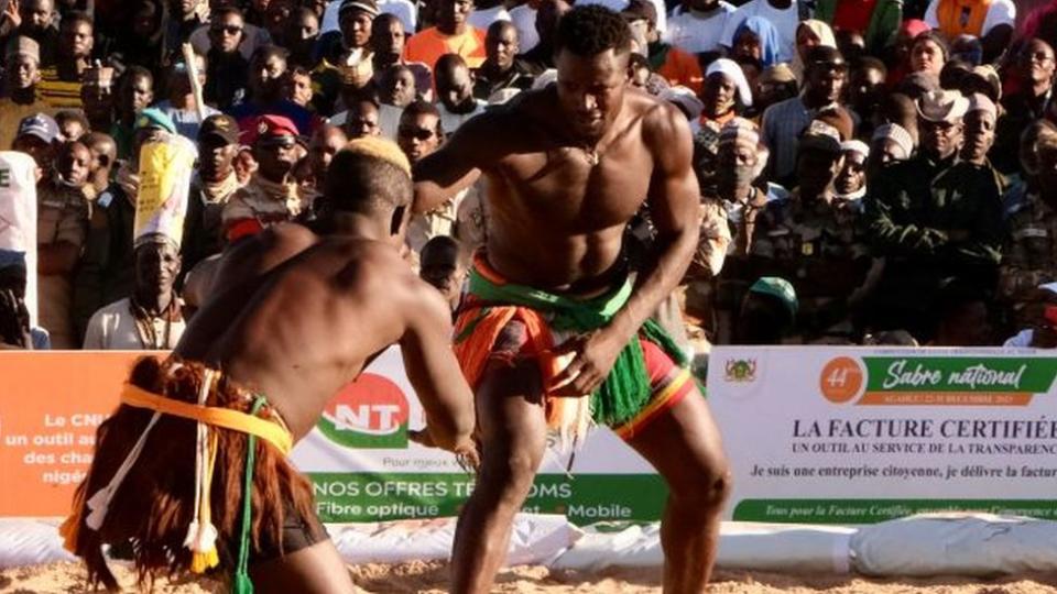 Wrestlers fight during semi final of the National Sabre, a traditional wrestling competition in Agadez, Niger - Sunday 31 December 2023