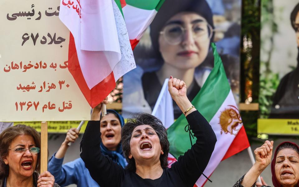 Protesters shout slogans critical of the Iranian regime in central Berlin on Monday.