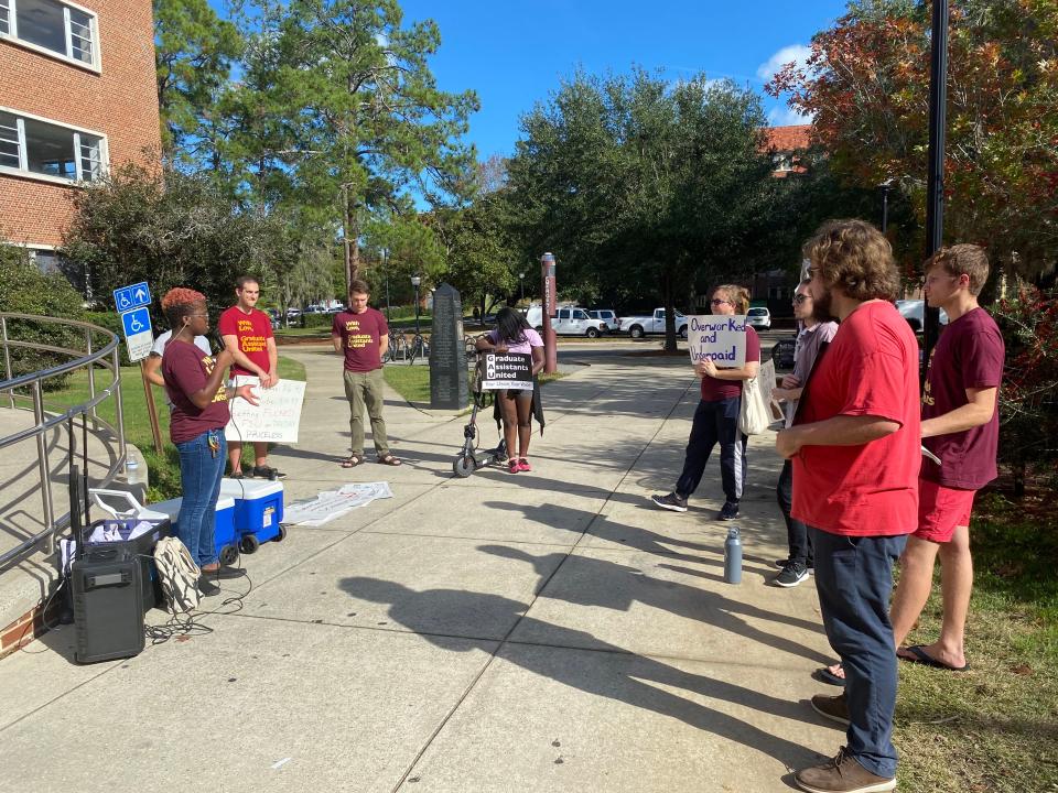 FSU's Graduate Assistants United  Organizing Chair Lee Robertson speaks to students during the labor union's rally in front of Strozier Library on Tuesday, December 6, 2022.