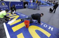 Crews clean the finish line before the start of the 119th running of the Boston Marathon in Boston, Massachusetts April 20, 2015. REUTERS/Gretchen Ertl