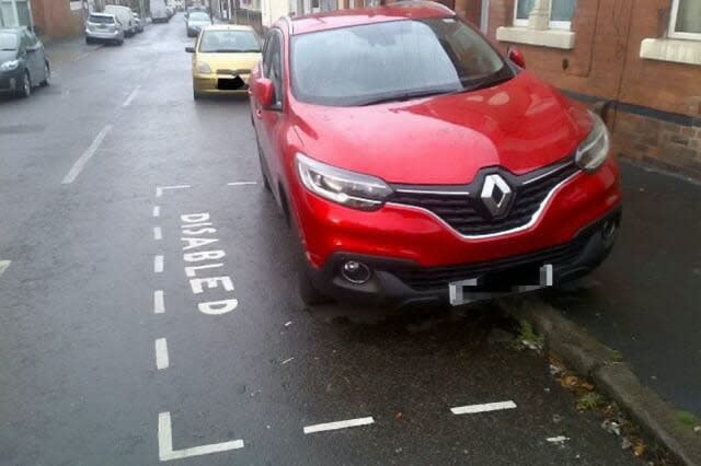 Disabled woman paints her own parking lines on road