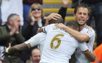 Football - Swansea City v Manchester United - Barclays Premier League - Liberty Stadium - 30/8/15 Andre Ayew (L) celebrates scoring the first goal for Swansea with Gylfi Sigurdsson and Ashley Williams Reuters / Rebecca Naden Livepic