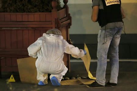 French investigating police in protective clothing work around weapon cartridges on the train platform in Arras, France, August 21, 2015. REUTERS/Pascal Rossignol