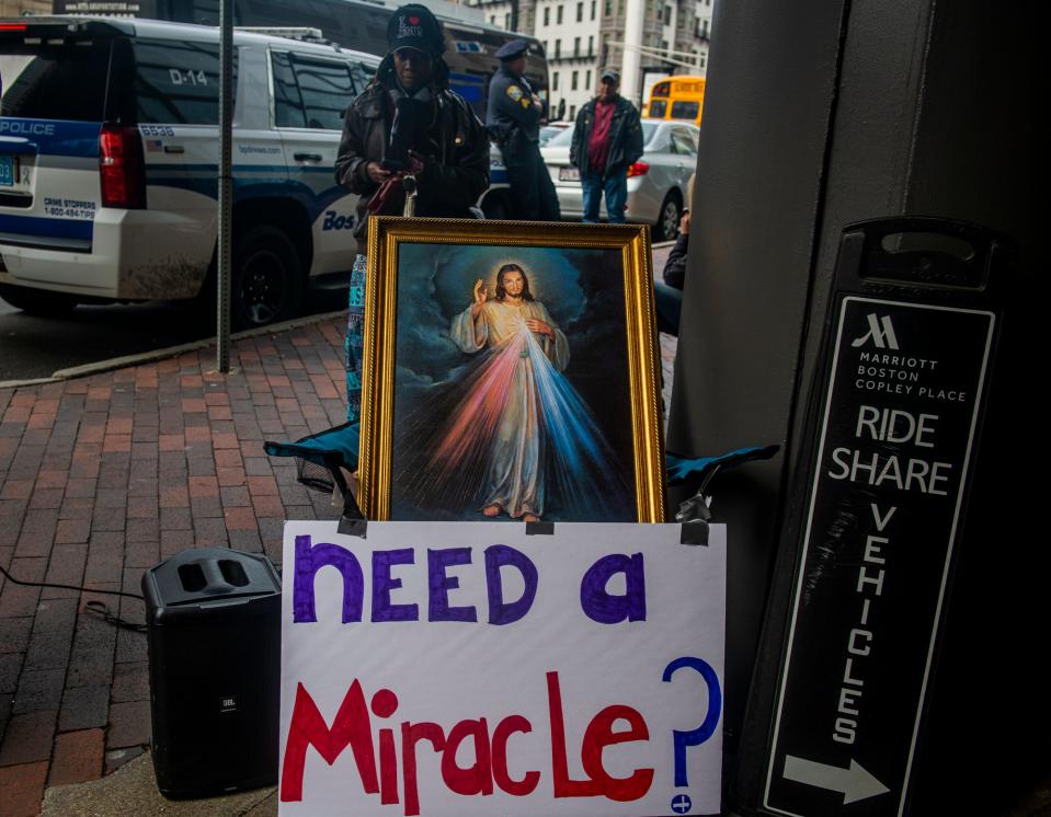 People protesting SatanCon stand outside Copley Place in Boston, Mass., on April 28, 2023.