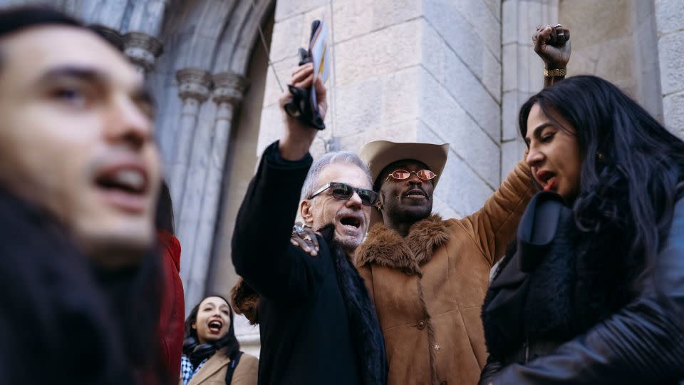 Yves Mathieu-East, right, joins the crowd in chanting "Cecilia!" after her funeral. - Laura Oliverio/CNN