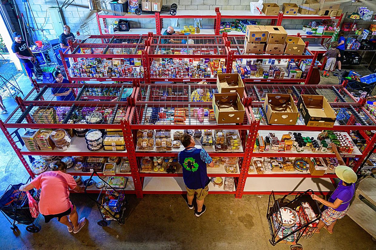 People choose groceries at a food pantry run by Epic-Cure in St. Augustine on Thursday, April 28, 2022. 
