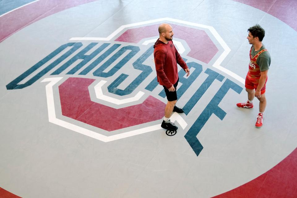 May 21, 2024; Columbus, OH, USA; Ohio State wrestling assistant coach Logan Stieber talks to Vinny Kilkeary during a voluntary practice at the Jennings Family Wrestling Practice Facility at the Covelli Center. Stieber is among the assistants who has had to step up since head coach Tom Ryan had a car accident on April 23.