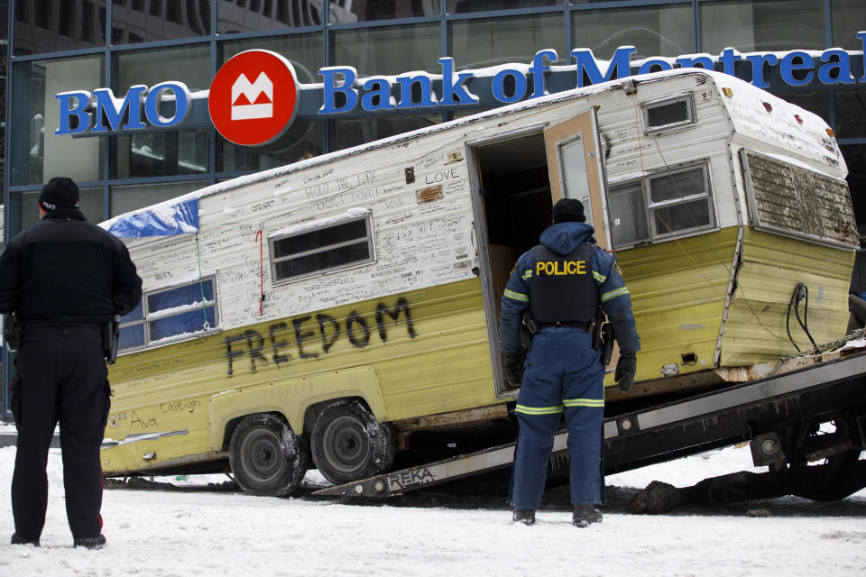 A camper is towed away by authorities clearing a trucker protest that was aimed at COVID-19 measures, in Ottawa, on Sunday, Feb. 20, 202. (Cole Burston/The Canadian Press via AP)