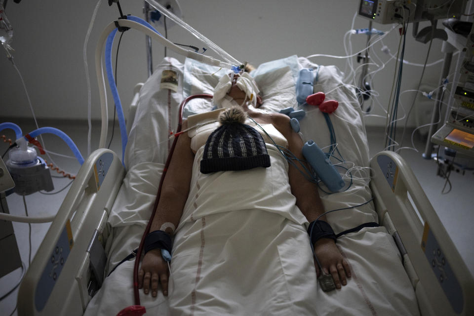 FILE - A patient with COVID-19 lies on a bed with a ventilator in the intensive care unit at the la Timone hospital in Marseille, southern France, Thursday, Dec. 23, 2021. The World Health Organization says member countries on Saturday, June 1, 2024, approved a series of new steps to improve global preparedness for and response to pandemics like COVID-19 and mpox. (AP Photo/Daniel Cole, File)