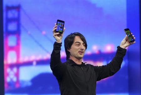 Joe Belfiore, vice president of the operating system group at Microsoft, holds a pair of mobile phones featuring the new Windows 8.1 operating system during the company's "build" conference in San Francisco, California April 2, 2014. REUTERS/Robert Galbraith