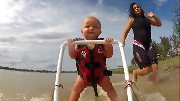 Ryder's mum runs beside him as he skis on the shore of Lake Dyer.