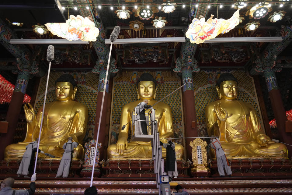 Buddhists monks clean Buddha statues ahead of the upcoming birthday of Buddha on May 15, at the Jogye temple in Seoul, South Korea, Tuesday, May 7, 2024. (AP Photo/Ahn Young-joon)