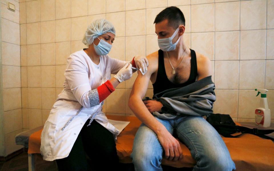 A man is injected with Sputnik V vaccine in the rebel-controlled city of Donetsk, Ukraine - Reuters