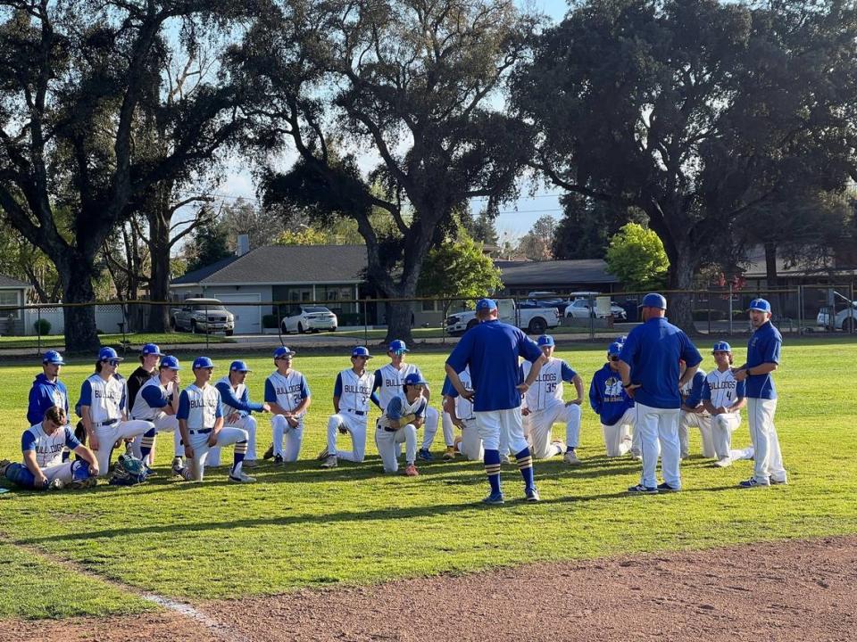 Turlock High baseball coach Mike Souza talks with his team after Game 1 of the Central California Athletic League series against Gregori. The Bulldogs won the game 8-1 en route to taking the season series.