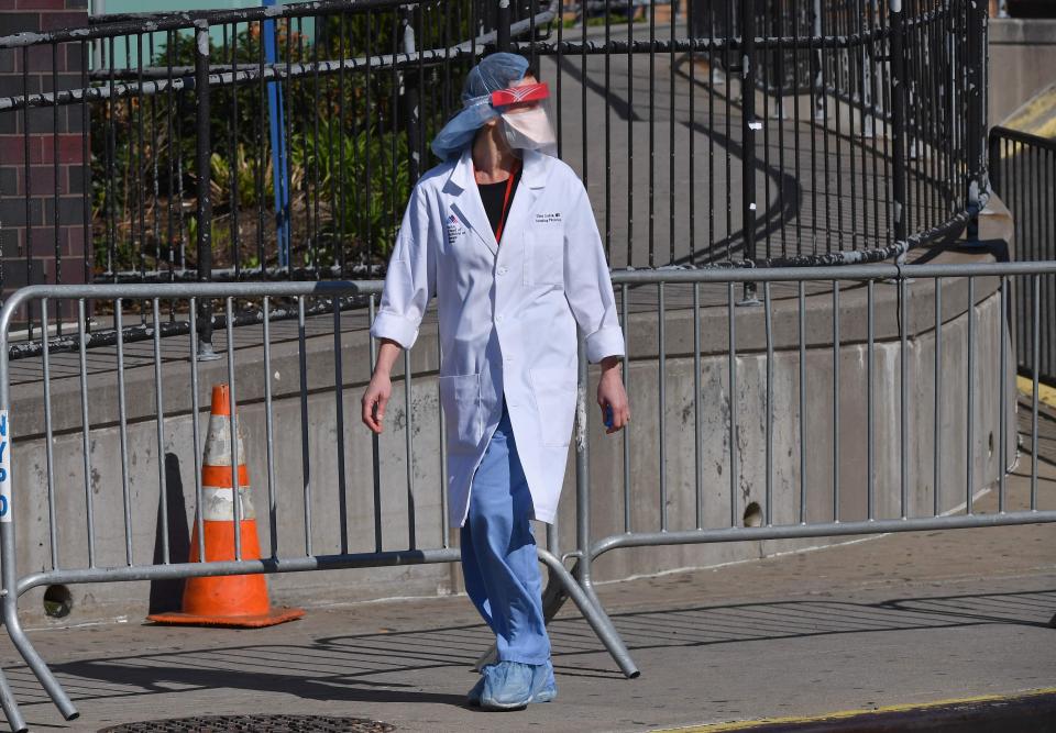 A physician outside Elmhurst Hospital Center in the Queens borough of New York City on March 26, the day after officials reported 13 COVID-19 patients had died at the hospital in a 24-hour span.