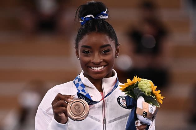 USA's Simone Biles poses with her bronze medal during the podium ceremony of the artistic gymnastics women's balance beam at Ariake Gymnastics Centre in Tokyo on Aug. 3. (Photo: LIONEL BONAVENTURE via Getty Images)