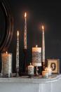 <p>Wrap black lace around white candles of varied sizes for a hauntingly chic bash. </p>