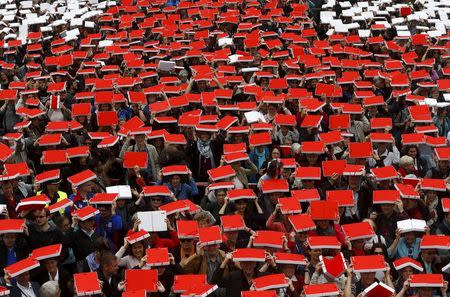 More than 2,800 Swiss Red Cross members show the Red Cross sign to commemorate their 150 years anniversary on the Federal Square in front of the Swiss Parliament in Bern, Switzerland April 2, 2016. REUTERS/Ruben Sprich