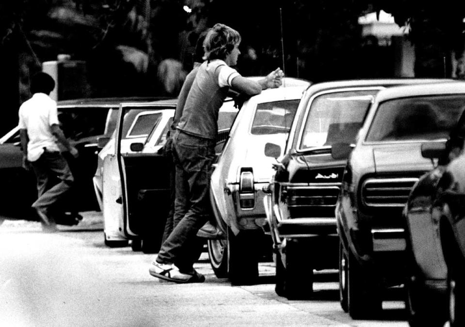 Student stand by their cars in the Coral Gables High parking lot in 1978. Joe Rimkus, Jr./Miami Herald File
