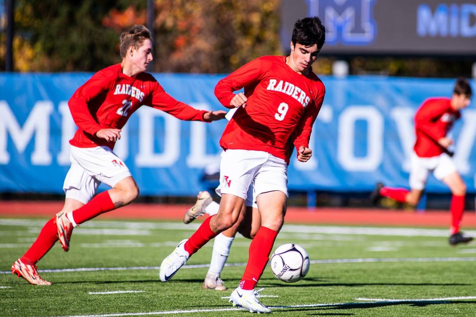 Red Hook's Colin MacDonald kicks the ball from a Lourdes defender during the boys Section 9 Class B championship soccer game in Middletown on Saturday, October 29, 2022.