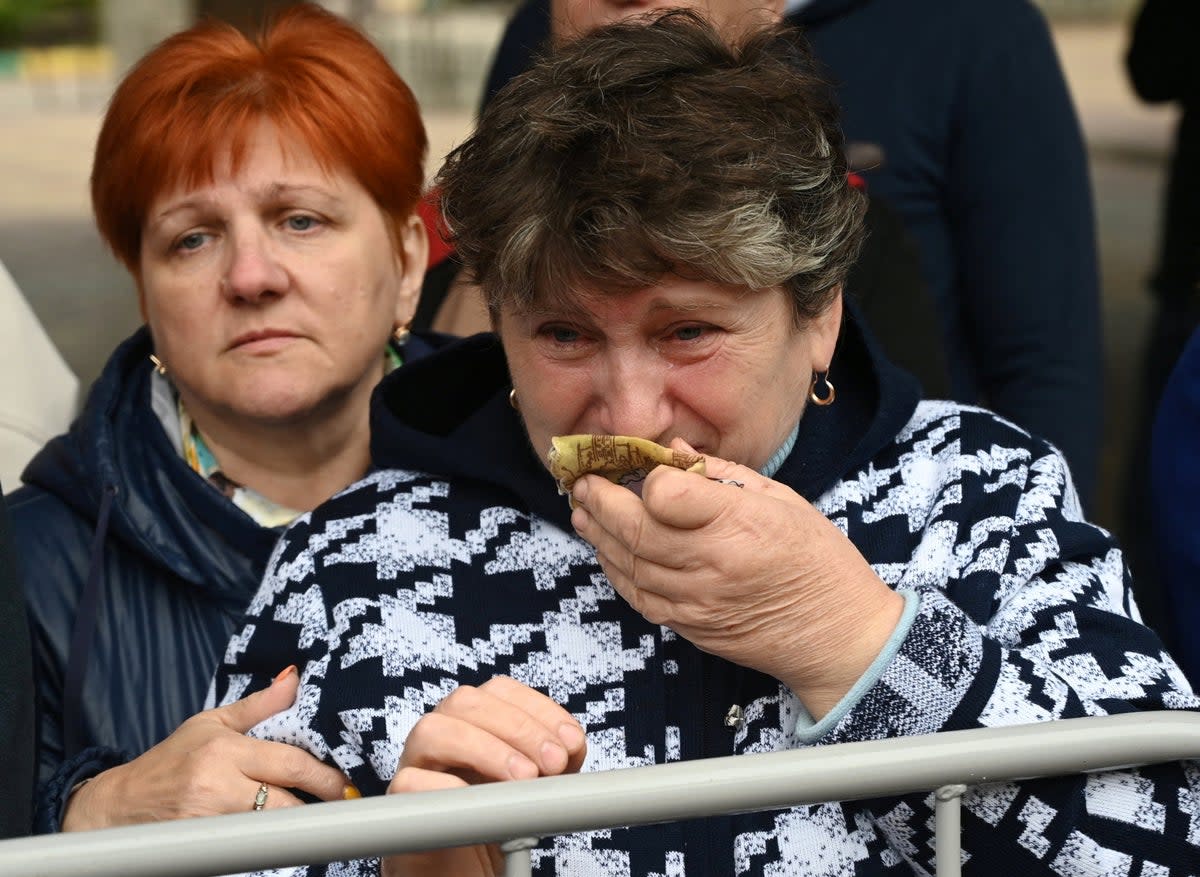 A woman in the city of Bataysk reacts as reservists drafted during partial mobilisation depart for military bases (Reuters)