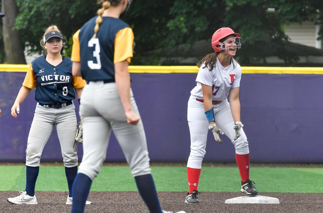Fairport's Nicole Allen, right, reacts after reaching second against Victor during the Section V Class AA Championship at Greece Odyssey High School, Saturday, May 28, 2022. No. 1 seed Fairport won the AA title with a 2-1 win over No. 2 seed Victor.