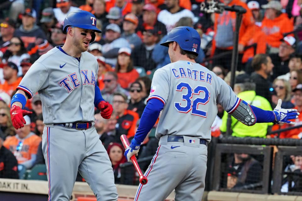 Texas Rangers catcher Mitch Garver (18) celebrates with center fielder Evan Carter (32) after hitting a grand slam home run during the third inning against the Baltimore Orioles during game two of the ALDS for the 2023 MLB playoffs at Oriole Park at Camden Yards.