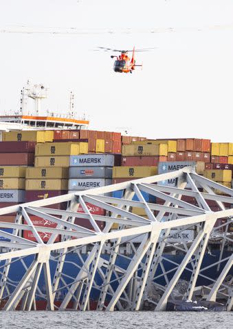 <p>JIM LO SCALZO/EPA-EFE/Shutterstock</p> A helicopter flies above the scene in Baltimore