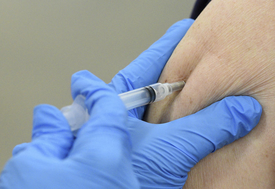 A COVID-19 vaccine is administered as Kane County opened its first COVID-19 mass vaccination site in Batavia, Ill., on Friday, March 19, 2021. (Rick West/Daily Herald via AP)