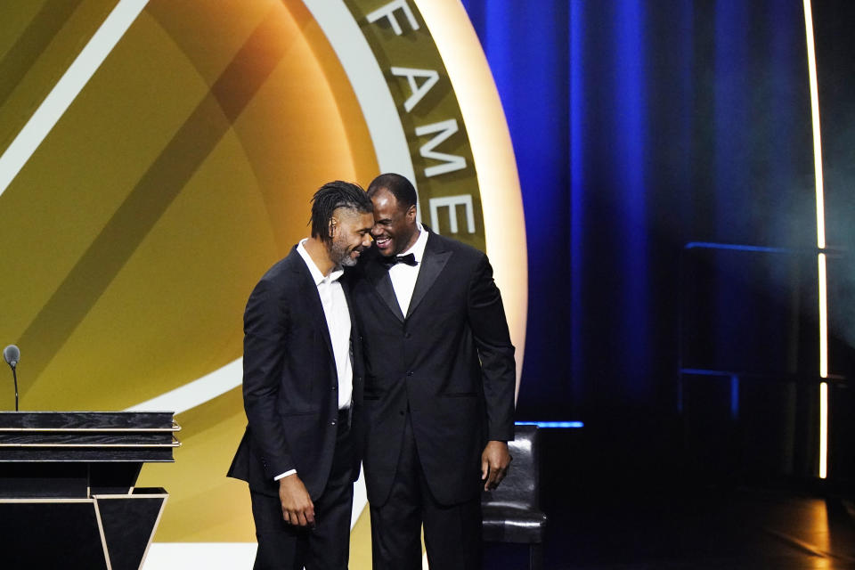 Tim Duncan, left, smiles with presenter David Robinson after being enshrined with the 2020 Basketball Hall of Fame class Saturday, May 15, 2021, in Uncasville, Conn. (AP Photo/Kathy Willens)