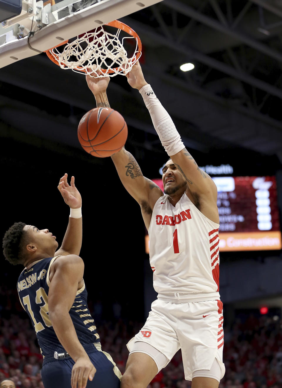 Dayton's Obi Toppin (1) dunks over George Washington's Jameer Nelson Jr (12) during the first half of an NCAA college basketball game Saturday, March 7, 2020, in Dayton, Ohio. (AP Photo/Tony Tribble)