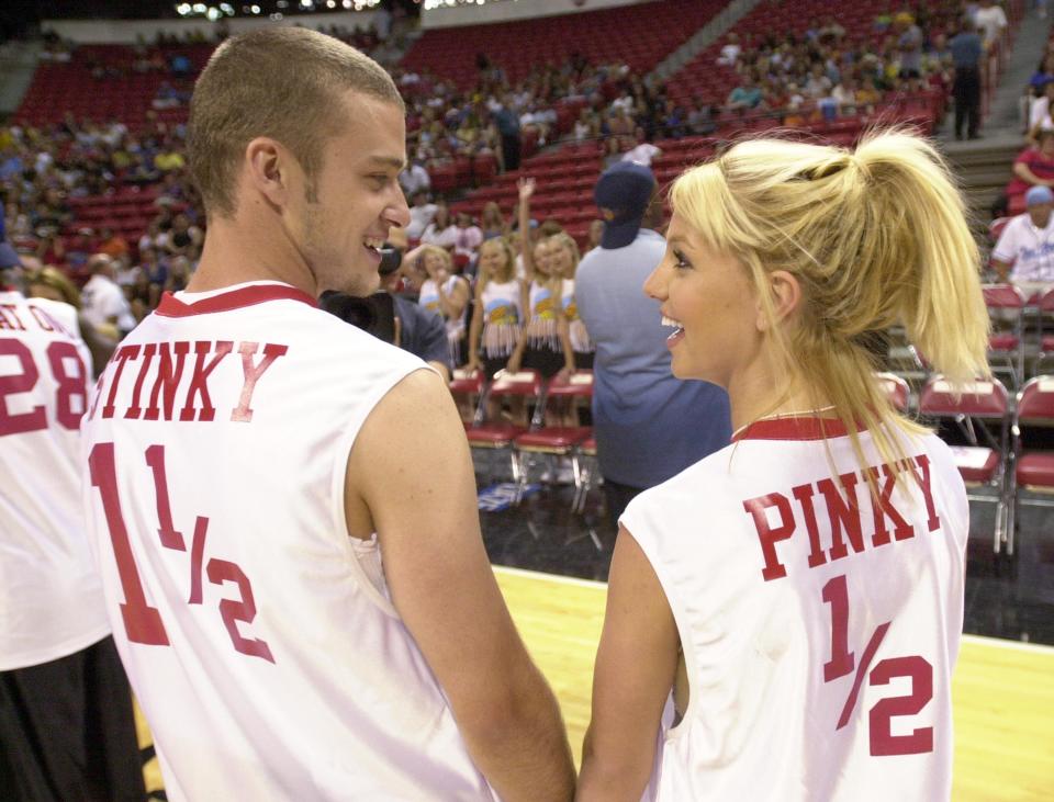 Justin Timberlake and Britney Spears wearing basketball jerseys.