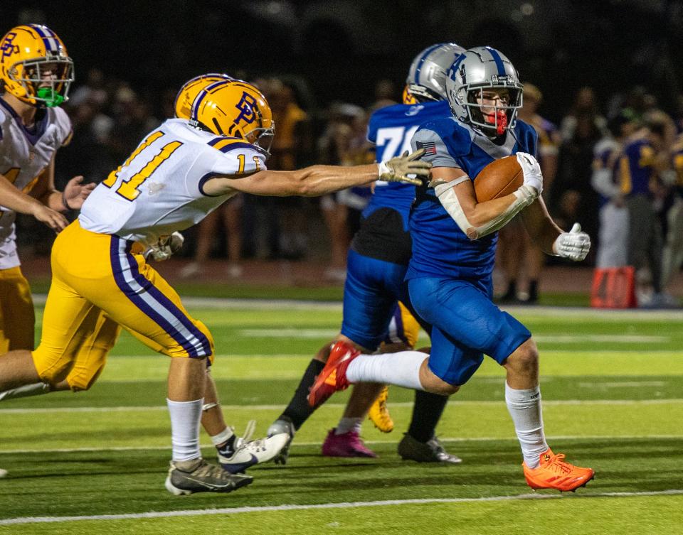 Auburn’s Bradyn Belanger breaks free and runs for a touchdown against Bay Path.