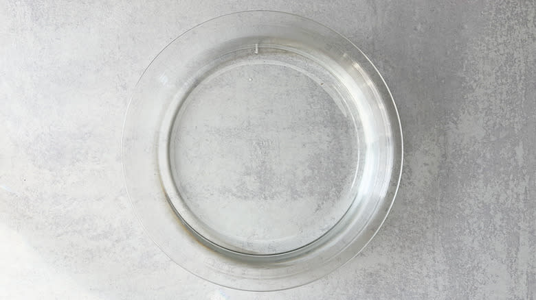 Pie plate filled with water on countertop