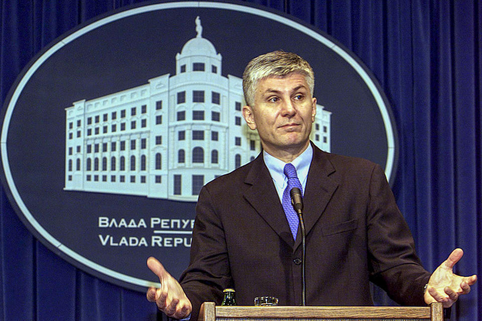 FILE - Serbia's slain prime minister Zoran Djindjic gestures during a press conference in Belgrade, Serbia, on Dec. 26, 2002. In 2003, two years after he orchestrated Milosevic's extradition to the U.N. war crimes tribunal in The Hague, Netherlands in 2001, Djindjic was gunned down by a special paramilitary unit that used to fight in Bosnia and Croatia. That paved the way for the fall of his government and gradual disintegration of Serbia's fragile democracy. (AP Photo/Darko Vojinovic, File)