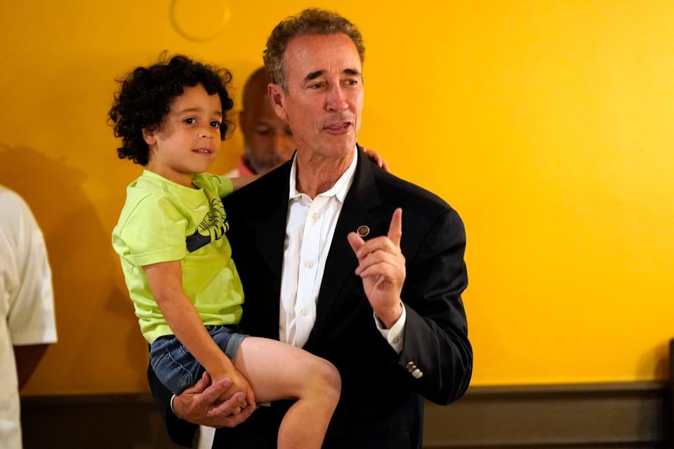 Virginia state Sen. Joe Morrissey holds his son Maverick as he speaks to supporters, Tuesday, June 20, 2023, in Petersburg, Va. Morrissey conceded to former Delegate Lashrecse Aird in a Democratic primary for a newly redrawn Senate district.