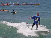 OCEANSIDE, CA - MAY 6: Surfers ride their boards out into the surf for a ceremony during a "paddle-out" in honor of NFL star Junior Seau on May 6, 2012 in Oceanside, California. Seau, who played for various NFL teams including the San Diego Chargers, Miami Dolphins and New England Patriots was found dead in his home on May 2nd of an apparent suicide. Family members have decided to donate his brain for research on links between concussions and possible depression. (Photo by Sandy Huffaker/Getty Images)