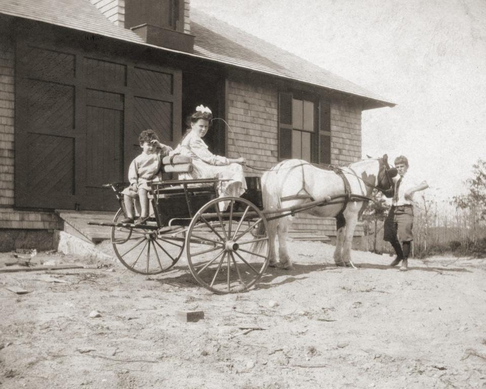 Three of Howland Davis' children are ready to take a ride outside the barn at the Davis-Douglas Farm in Plymouth in 1901.