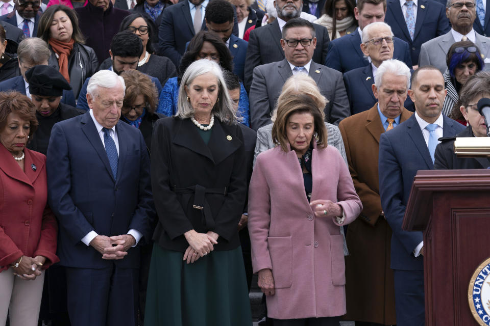 Incoming House Minority Leader Hakeem Jeffries, D-N.Y., accompanied by from left, Rep. Maxine Waters, D-Calif., Rep. Steny Hoyer, D-Md., incoming House Minority Whip Rep. Katherine Clark, D-Mass., Rep. Nancy Pelosi, D-Calif., along with members of Congress and family of fallen officers, pauses for a moment of silence during a ceremony marking the second year anniversary of the violent insurrection by supporters of then-President Donald Trump, in Washington, Friday, Jan. 6, 2023. (AP Photo/Jose Luis Magana)