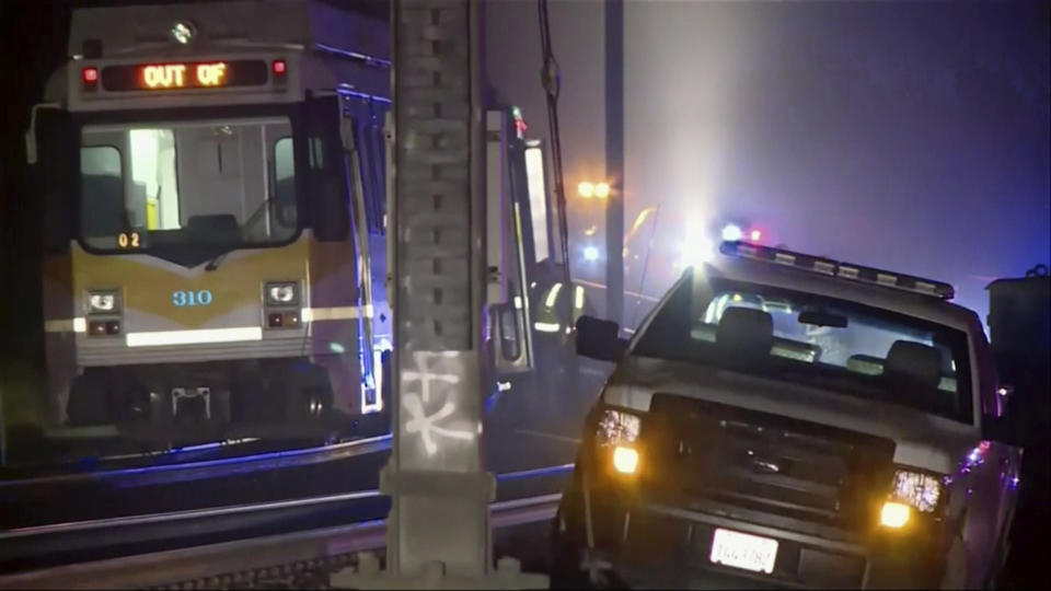 In this image from video, a light rail train, left, sits after derailment in Sacramento, Calif., Thursday night, Aug. 22, 2019. Authorities say more than two dozen people have been injured in the light rail train derailment in Northern California. (KOVR via AP)