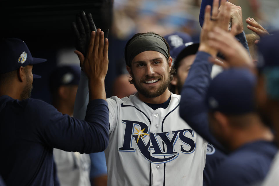 Tampa Bay Rays' Josh Lowe celebrates in the dugout after scoring against the Detroit Tigers during the third inning of a baseball game Saturday, April 1, 2023, in St. Petersburg, Fla. (AP Photo/Scott Audette)