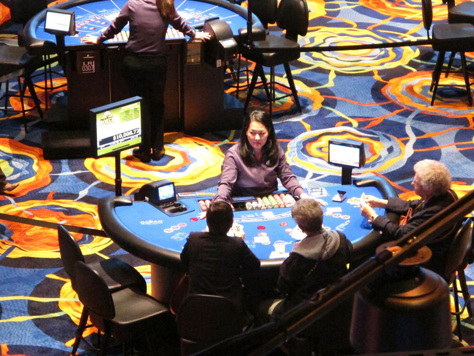 This June 25, 2018 photo shows a card game under way at the Ocean Casino Resort in Atlantic City N.J. The casino formerly known as Revel will turn a profit in May after months of steep losses. (AP Photo/Wayne Parry)